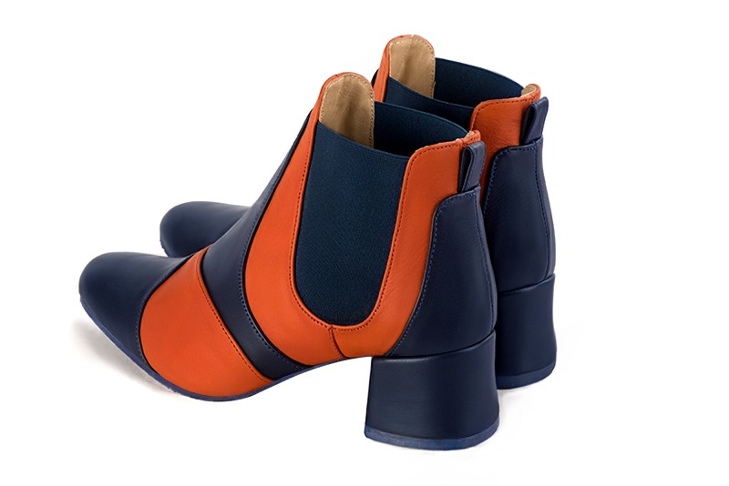 Navy blue and clementine orange women's ankle boots, with elastics. Round toe. Low flare heels. Rear view - Florence KOOIJMAN